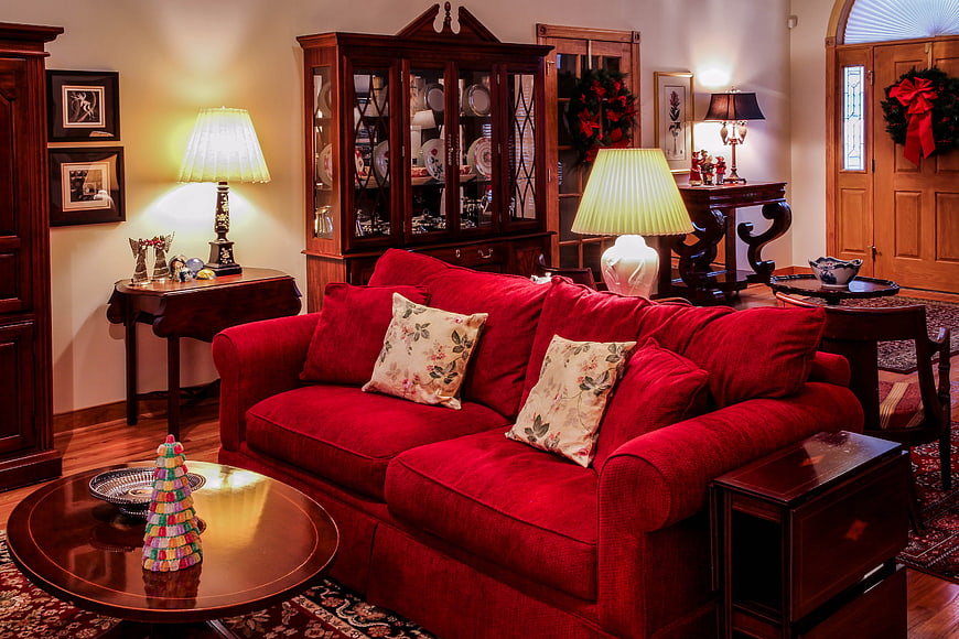 Cozy Christmas Living Room With Red Sofa And Antique Wood Furniture