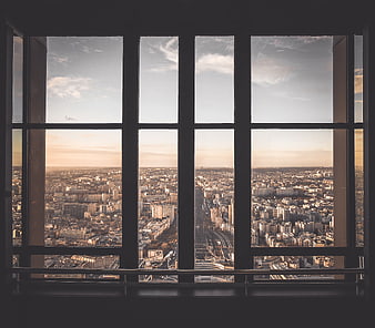 Cityscape View Through Large Window Grid at Sunset