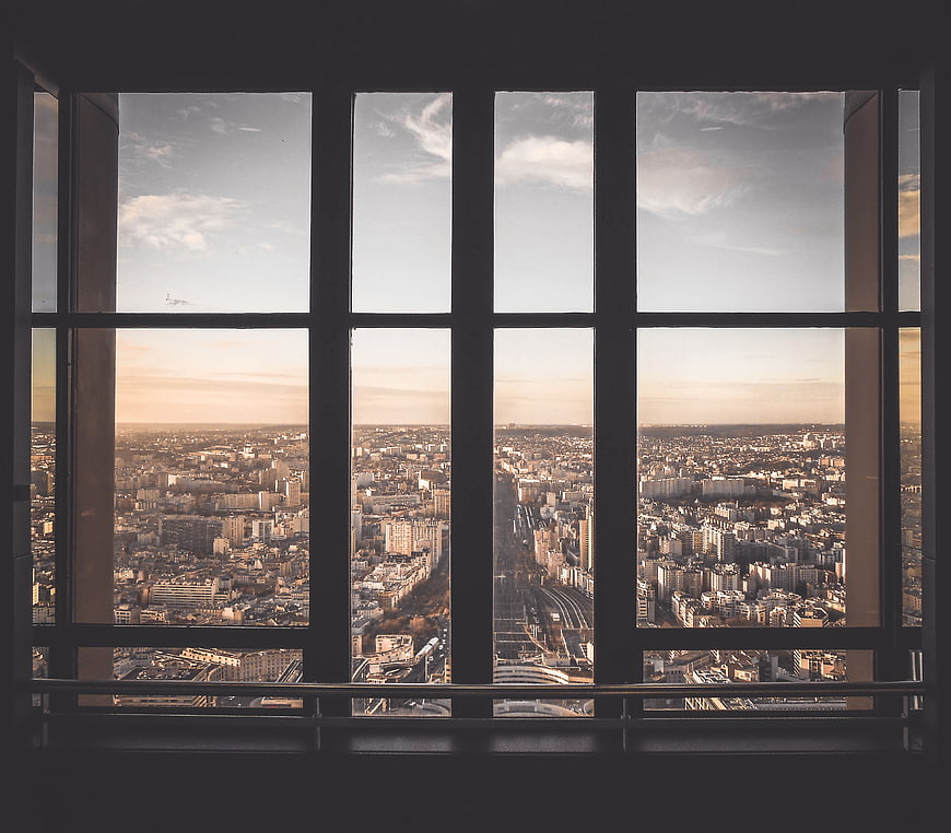 Cityscape View Through Large Window Grid at Sunset