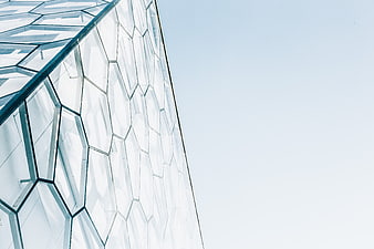 Modern Hexagonal Glass Architecture Against Blue Sky