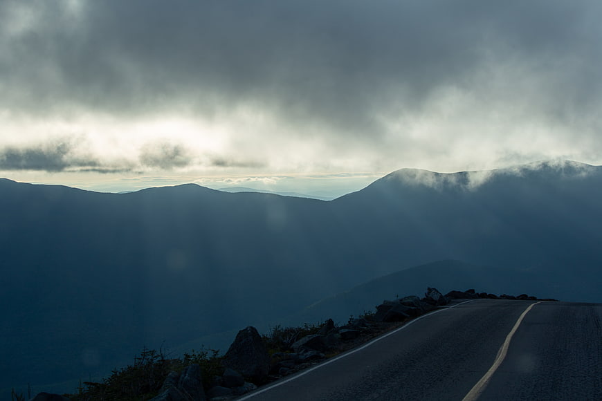 Dramatic Misty Mountain Road with Sun Rays