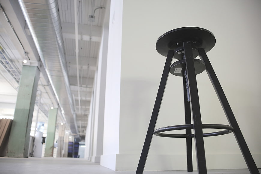 Low angle view of black industrial stool in modern warehouse