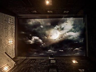 Dramatic Night Sky View From Stone Courtyard With Full Moon
