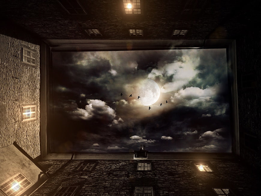 Dramatic Night Sky View From Stone Courtyard With Full Moon