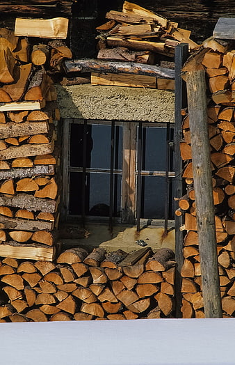 Stacked Firewood Logs Framing a Rustic Window