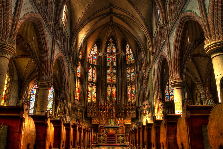 Gothic Cathedral Interior with Stained Glass and Brick Arches