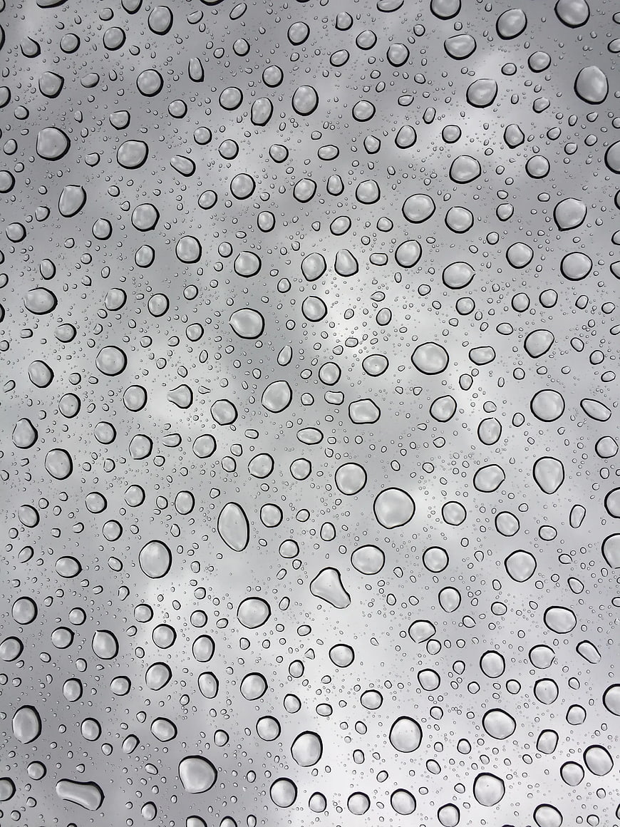 Raindrops on glass window texture background