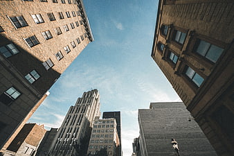 Low angle view of city skyscrapers against blue sky