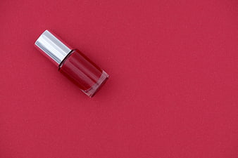 Red Nail Polish Bottle On Pink Background