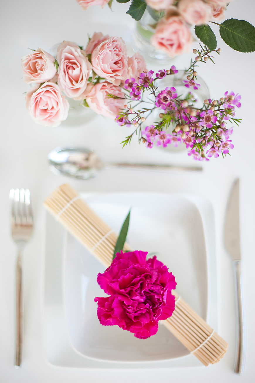 Elegant Flat Lay Table Setting with Pink Flowers and Uncooked Pasta