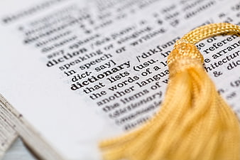 Close-up of dictionary page with yellow tassel bookmark