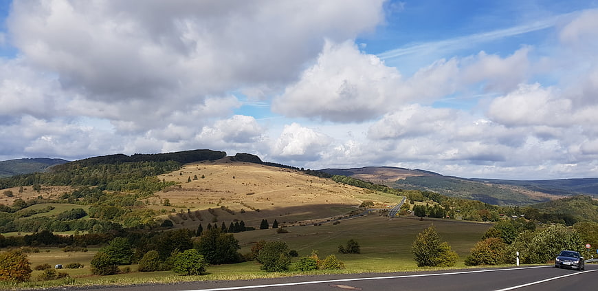 Panoramic View of Rolling Hills and Winding Road in Autumn