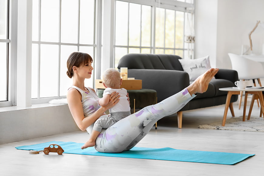 Mother doing yoga with baby at home