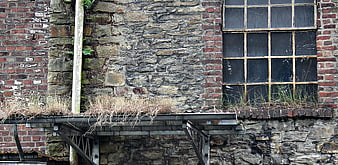 Weathered Brick and Stone Wall with Old Industrial Window