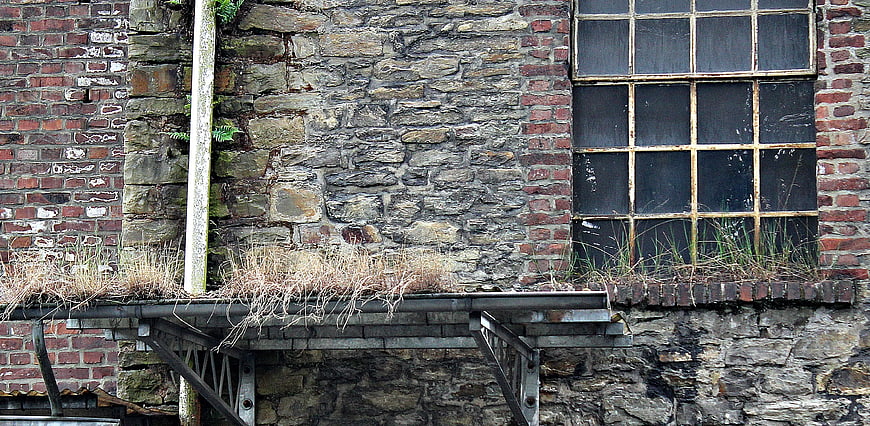 Weathered Brick and Stone Wall with Old Industrial Window