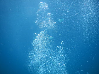 Underwater Bubbles Rising in Blue Ocean Water