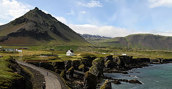 Icelandic Coastal Landscape With Mountain, Village, And Sea