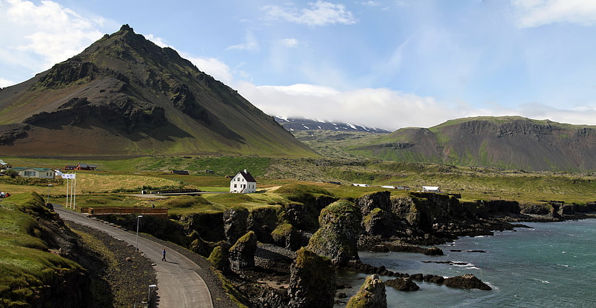 Icelandic Coastal Landscape With Mountain, Village, And Sea