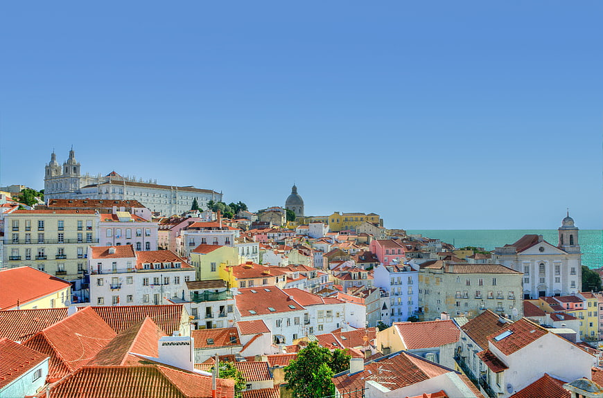 Colorful Alfama District Rooftops and Lisbon Skyline with Ocean View