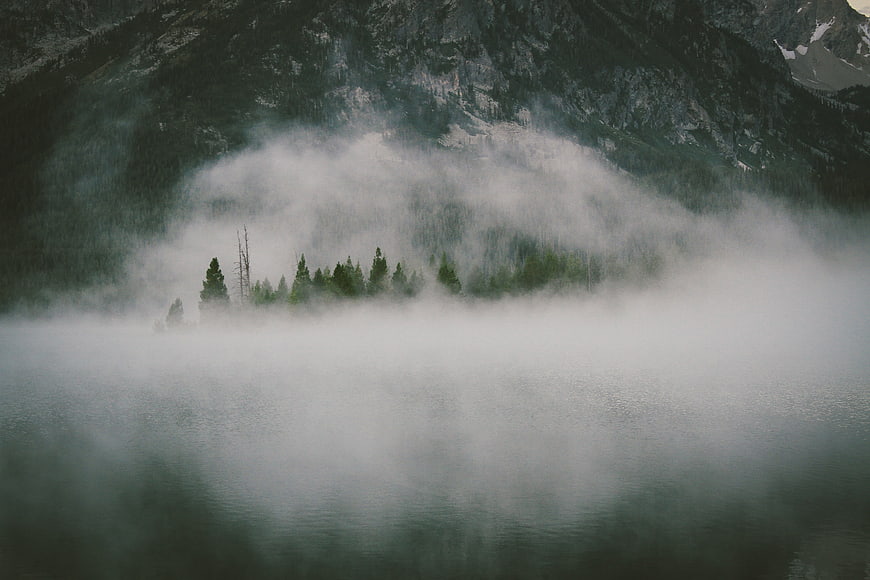 Misty Mountain Lake with Foggy Forest Reflection