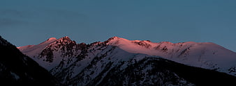 Snow-Capped Mountain Peaks Bathed in Pink Alpenglow at Dusk