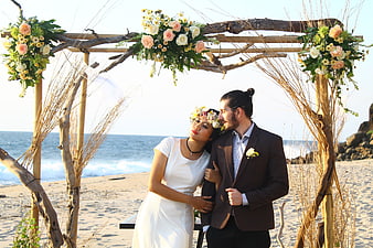 Romantic Beach Wedding Couple Under Floral Driftwood Arch