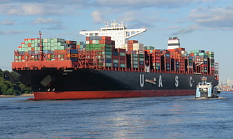 Large UASC Container Ship Navigating Waterway with Tugboat