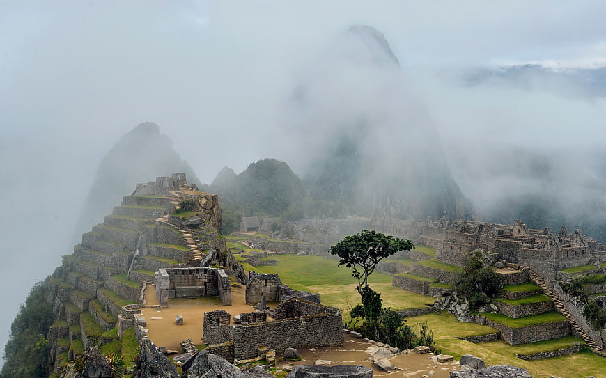 Machu Picchu ruins shrouded in mist and clouds