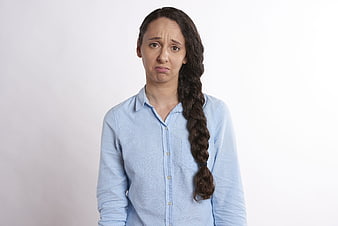 Portrait of a worried woman with a long braid looking concerned