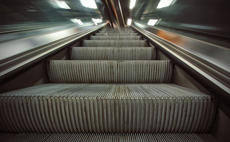 Low angle view of moving escalator steps in a subway station