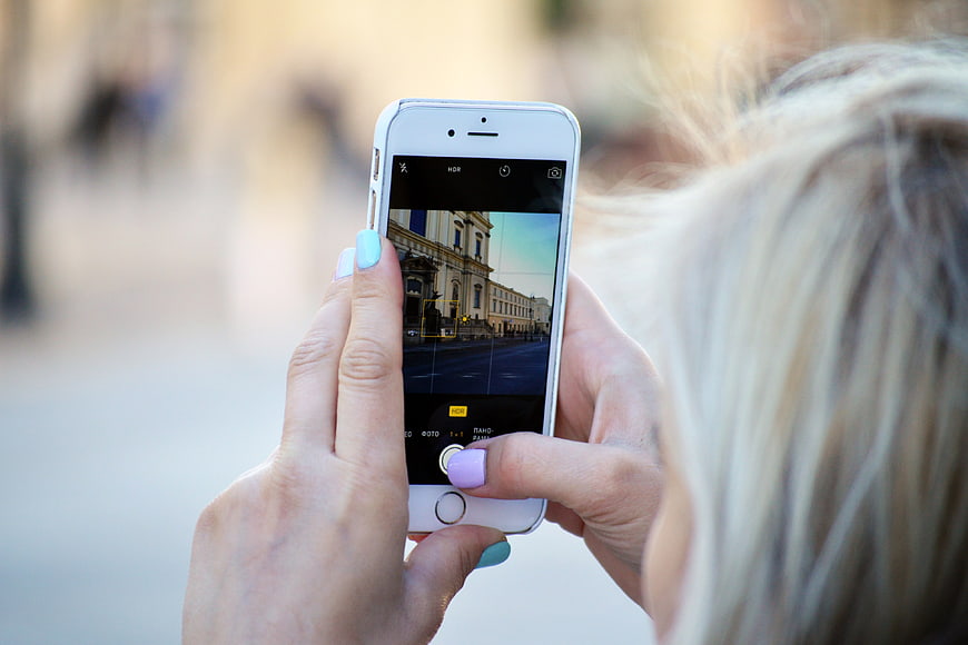 Woman Taking Photo of Architecture with Smartphone