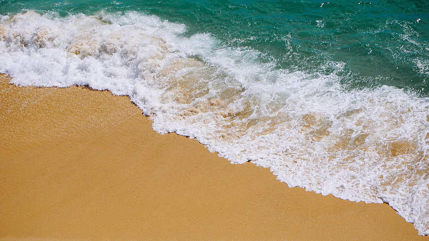 Aerial View of Turquoise Ocean Waves Washing on Golden Sand