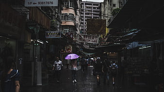 Rainy Asian Street Market with Purple Umbrella