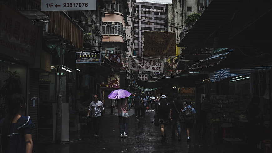 Rainy Asian Street Market with Purple Umbrella