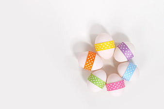 Decorated Easter Eggs with Polka Dot Ribbons on White Background