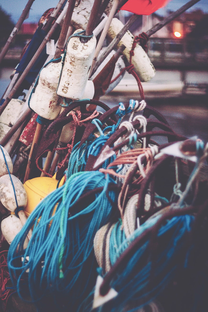 Close-up of tangled fishing ropes and buoys on a boat