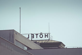 Rooftop Hotel Signage Against Clear Blue Sky