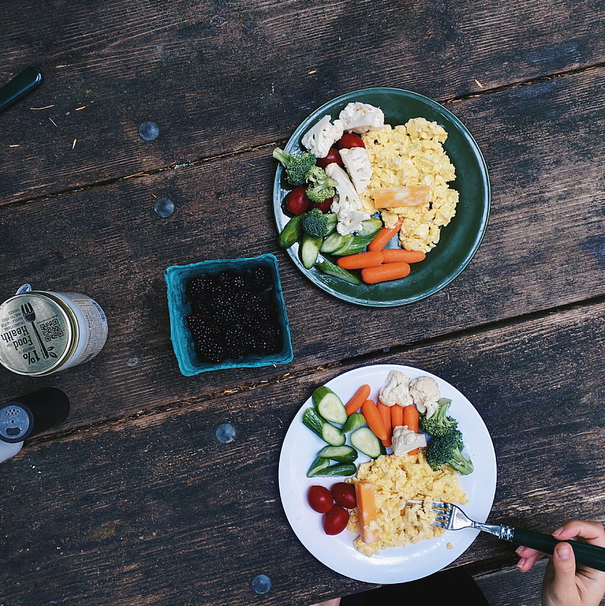 Healthy breakfast with eggs and vegetables on wooden table