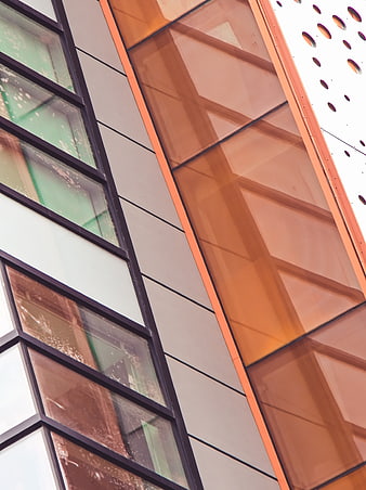 Modern building facade with orange glass and geometric patterns