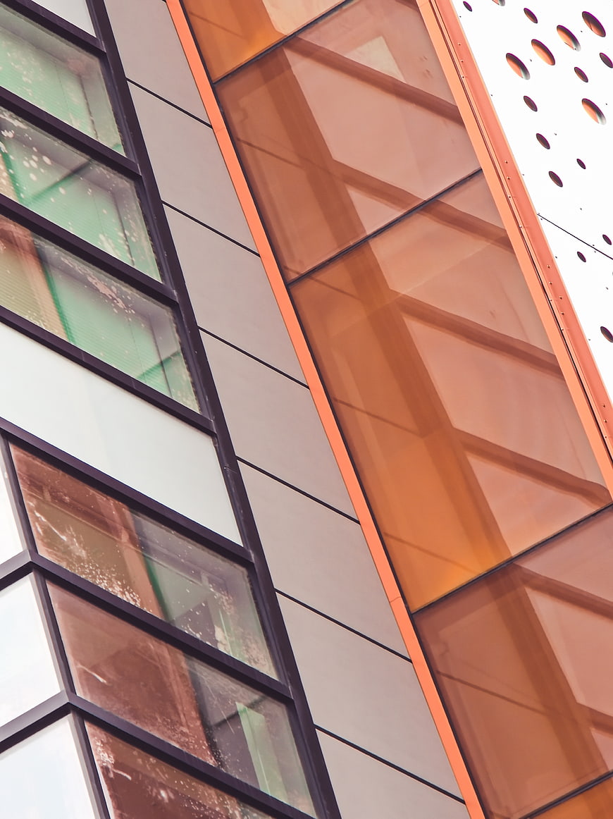 Modern building facade with orange glass and geometric patterns