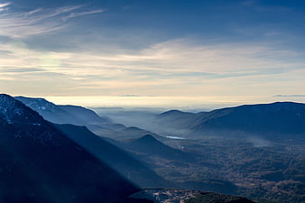 Misty Mountain Range Landscape With Blue Sky And Clouds