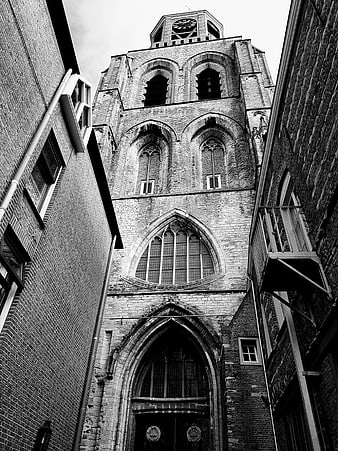 Low angle black and white view of historic church tower