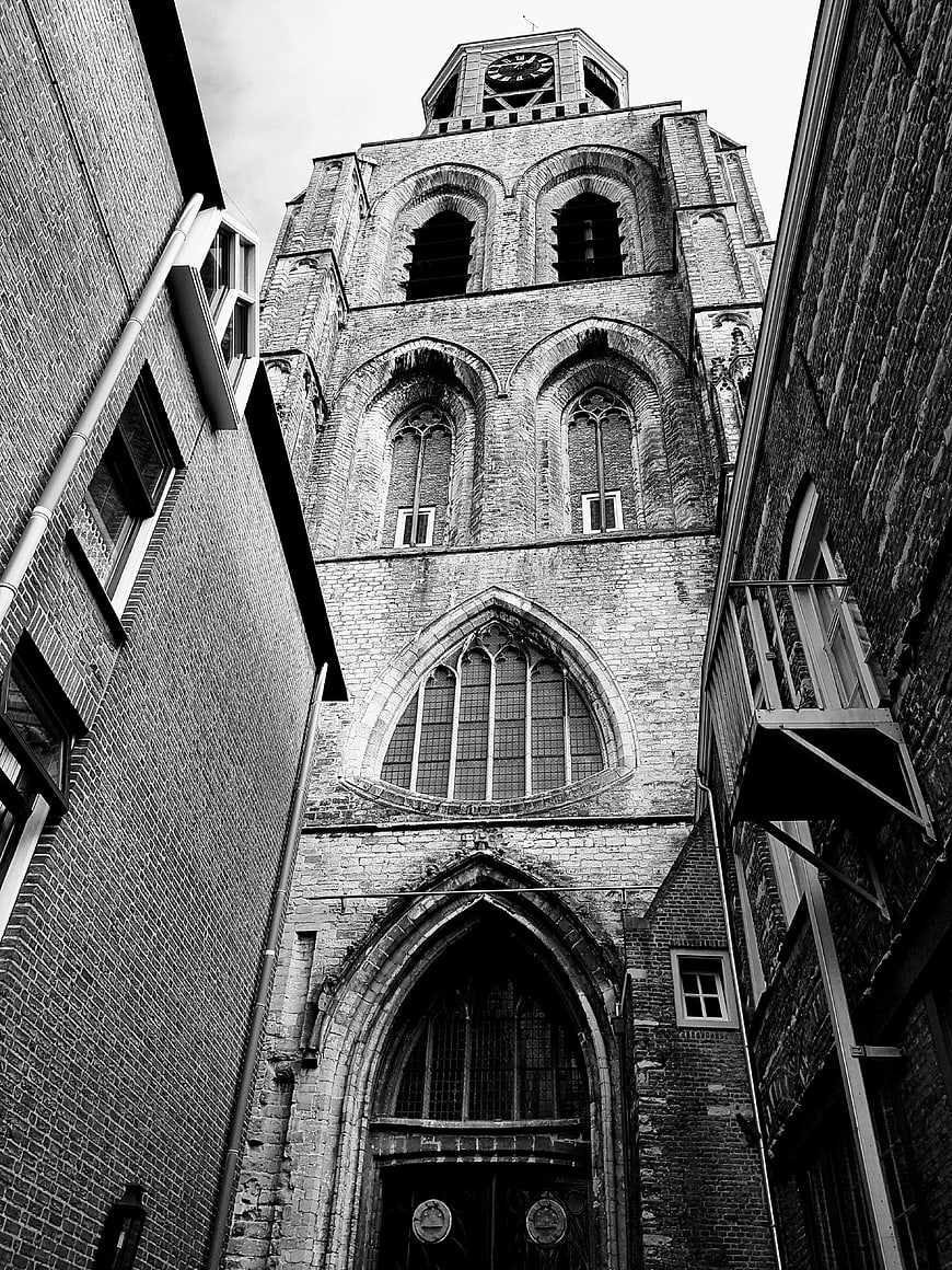 Low angle black and white view of historic church tower