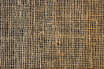 Close-up texture of woven burlap fabric on black background