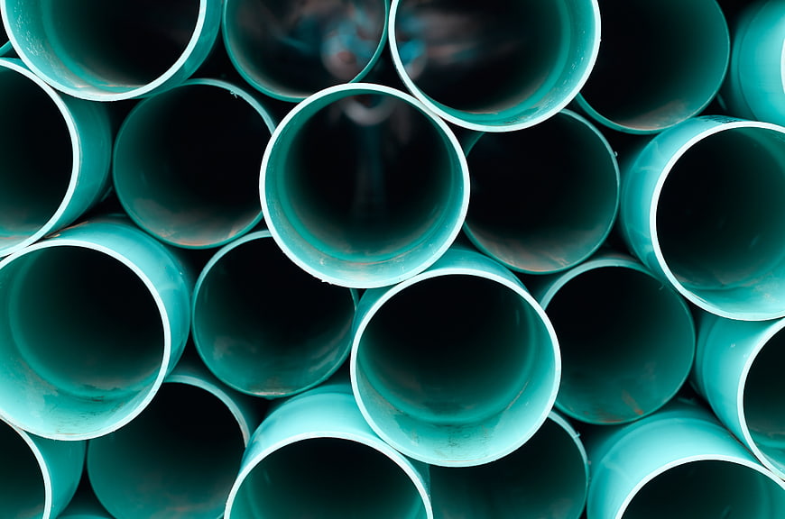 Stacked Teal PVC Pipes Industrial Background