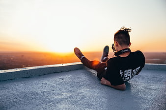 Photographer with Camera on Rooftop at Sunset