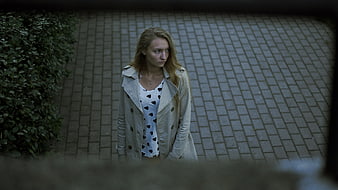 High angle view of young woman looking away on paved path