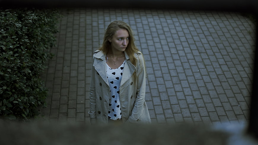 High angle view of young woman looking away on paved path