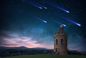 Stone Tower Under Starry Night Sky with Shooting Stars