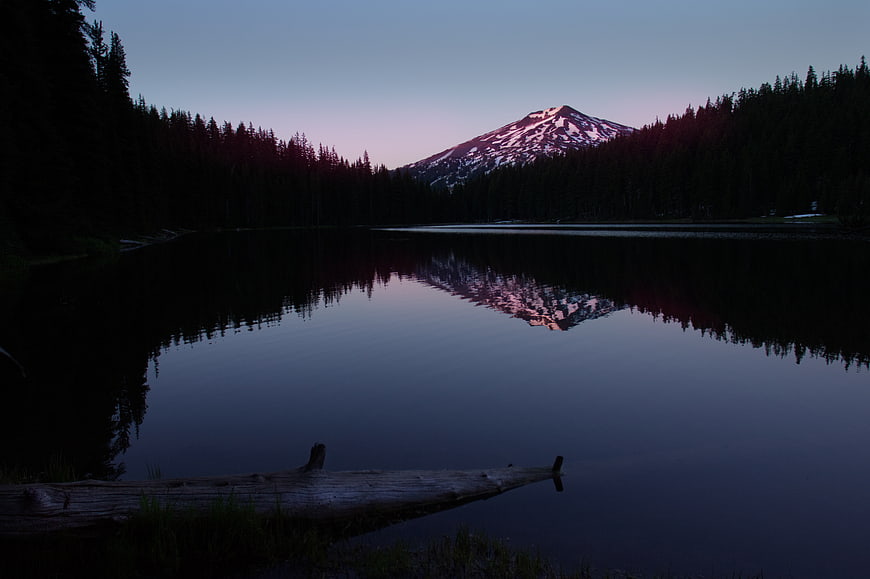 Serene Mountain Lake Reflection at Dusk with Snow-Capped Peak